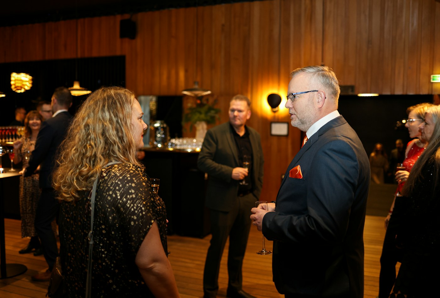 Two attendees talking at a formal business networking reception