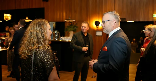 Two attendees talking at a formal business networking reception